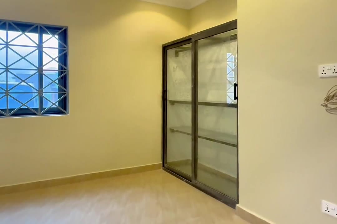 Bedroom with a built-in glass-door wardrobe